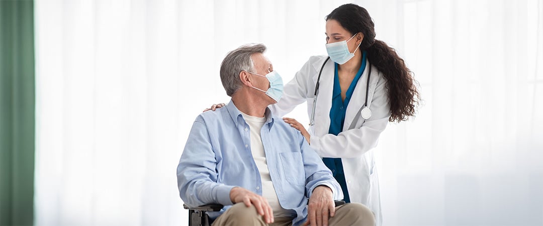 A nurse and patient smiling at each other